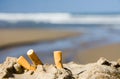 Three cigarettes on beach Royalty Free Stock Photo