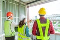 Civil engineers team with one female is discussing about transporation construction site