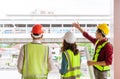 Three Civil engineers with one female is discussing about transporation construction site