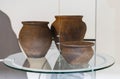 Three clay pots on display at the museum, close-up