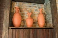 Three clay vases on wooden shelf. interior decoration, orient style