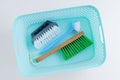 Three cleaning brushes with handle in a plastic box. White background Royalty Free Stock Photo