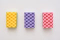 Three cleaning sponges isolated. Yellow,pink and purple cleaning sponges