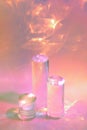 three clear glass cylinder podiums on pastel pink background