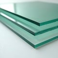 Three clear glass panels stack on white surface. Transparent sheets show subtle green tint, sharp edges. Material for Royalty Free Stock Photo