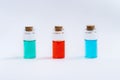 Three closed vials with colored contents.