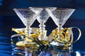 Three cocktail glasses with golden serpentine