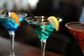 Three cocktails on the bar. Blue, green, red. Decorated with a lemon slice Royalty Free Stock Photo