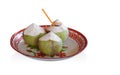Three coconuts placed on white and red tray, on white background, nature, food, copy space Royalty Free Stock Photo