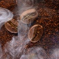 Three coffee beans lie on ground coffee close-up. Royalty Free Stock Photo