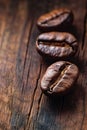 Three Coffee Beans on a Wooden Table