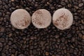 Three coffee biscuits lie in a row in the center on a grain coffee background Royalty Free Stock Photo