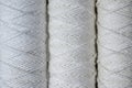 Three coils of white thread for sewing, close-up Royalty Free Stock Photo