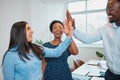 Three colleagues attempt high five and miss, candid moment in office workplace Royalty Free Stock Photo