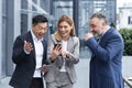 colleagues employees watch funny videos or look at photos, pictures memories looking at smartphone