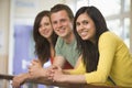 Three college students leaning on banister