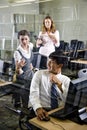 Three college students in library computer room Royalty Free Stock Photo