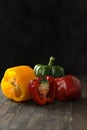 Bell peppers tricolor, dark background on black table Royalty Free Stock Photo