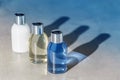 Three color bottles on a grey background. Beauty concept for body care and hygiene. Royalty Free Stock Photo