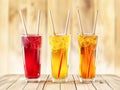 Three color fresh drink in tall glass with bamboo straw