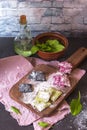 Three color homemade raw pink beetroot, green spinach and black cuttlefish ink pasta ravioli with cheese and parsley on a brown