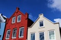 Three color houses staying in a row - blue , red and white