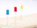 Three color leds in breadboard isolated in white background. Close up. Selective focus Royalty Free Stock Photo