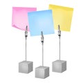 Three color notes on a metal memo holders clips. Notes on wire silver clamps with place for you text over white background.