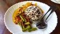 Three color rice with spicy yellow curry with pork and Stir fried pork belly and red curry paste with string bean in white dish Royalty Free Stock Photo