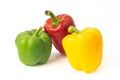 Three colored bell peppers on a white background Royalty Free Stock Photo