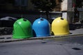 Three colored bins for sorting waste located in the city on the street.Trash Containers for Garbage Separation -- three colors for