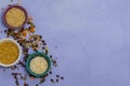 Three bowls with different types of rice and bulgur on a blue background, top, space to the right