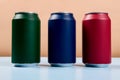 three colored cans of soft drinks closed on a light blue background Royalty Free Stock Photo