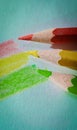 three colored crayon pencils