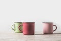 three colored cups on marble table Royalty Free Stock Photo