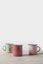 three colored cups on marble table Royalty Free Stock Photo