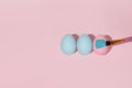 Three colored eggs in a row flat lay. Royalty Free Stock Photo
