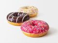 Three colored glazed doughnuts