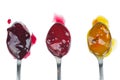 Three colored jam on a spoon isolated on a white background