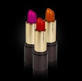 Three colored lipsticks Royalty Free Stock Photo
