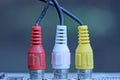 three colored old plugs with wires Royalty Free Stock Photo