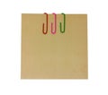 Three colored paper clips with blank notepaper. Sheet for your message or adding more text. Memo note with paper clips