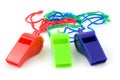 Three colored plastic whistles Royalty Free Stock Photo