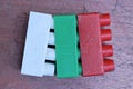 three colored red small plastic cubes bricks toy Royalty Free Stock Photo