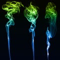 Three different colored smokes in black background