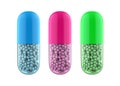 Three colored vitamin or antibiotics pills.