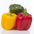 Three colorful bell peppers over white background Royalty Free Stock Photo