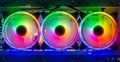 Three colorful bright rainbow led rgb pc fan air case cooler white desktop computer chassis. gaming modding water cooling and Royalty Free Stock Photo