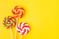 Three colorful Christmas candies on stick. Sweet food for birthday. Lollypop. Copy space. Flat lay Royalty Free Stock Photo