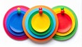 Three Colorful Circular Stacked Objects Attached with Pins on White Surface Royalty Free Stock Photo